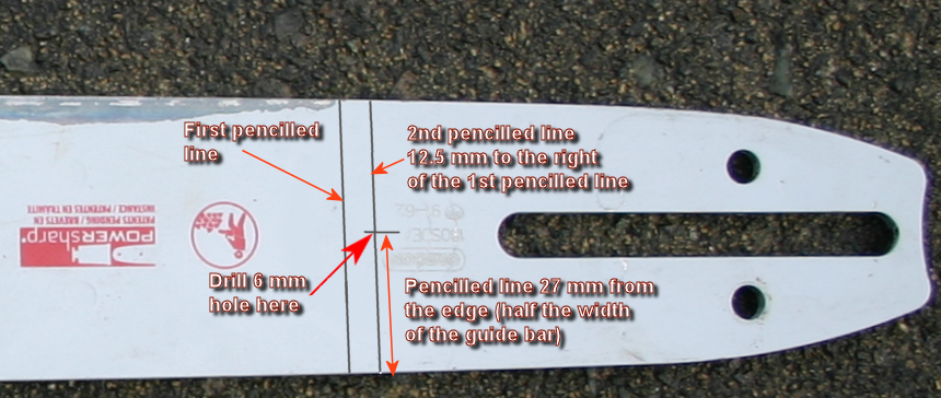 Marking the position of a rear bolting hole in a chainsaw guide bar.