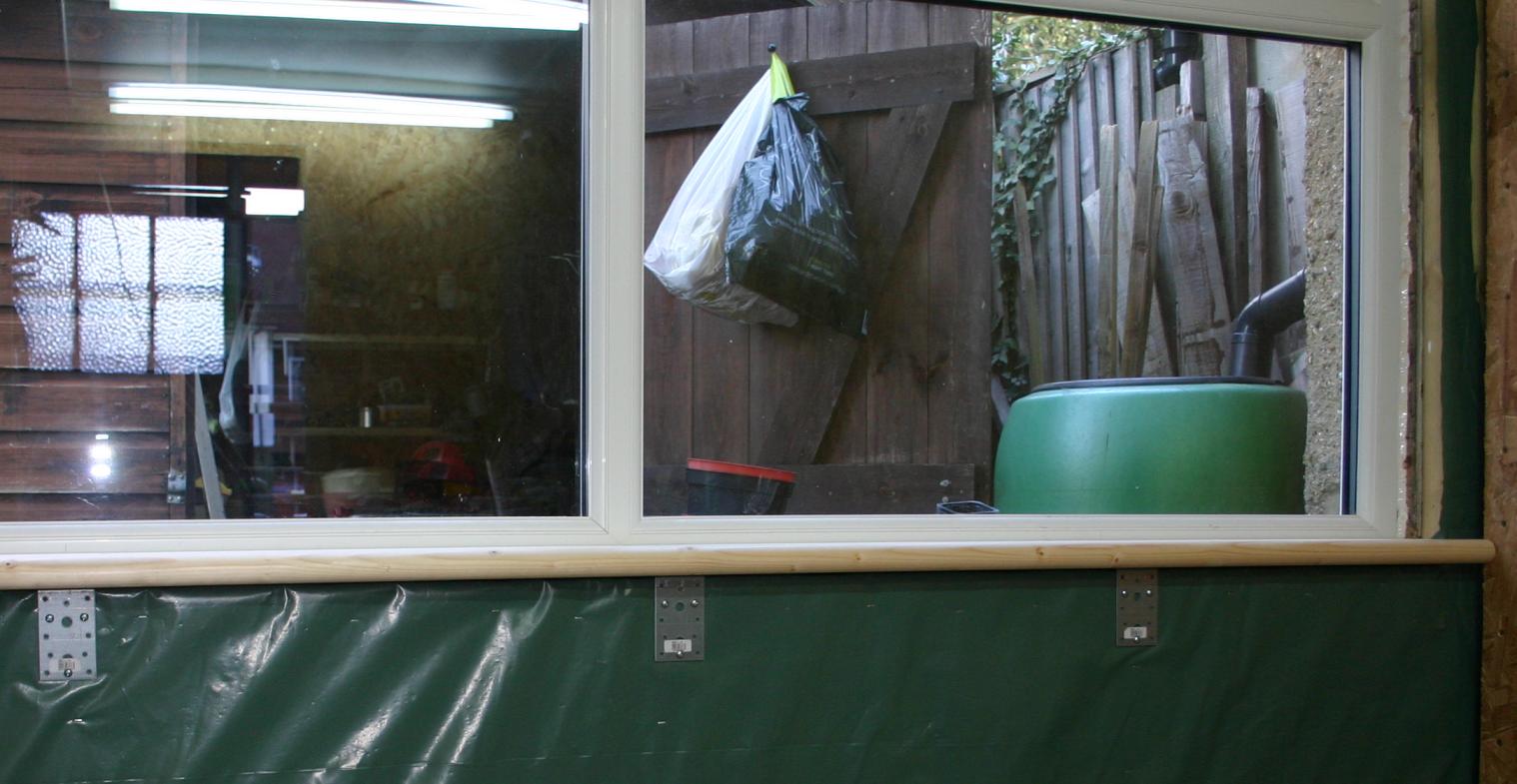 Window sill fixed by screwing brackets to wooden studwork.