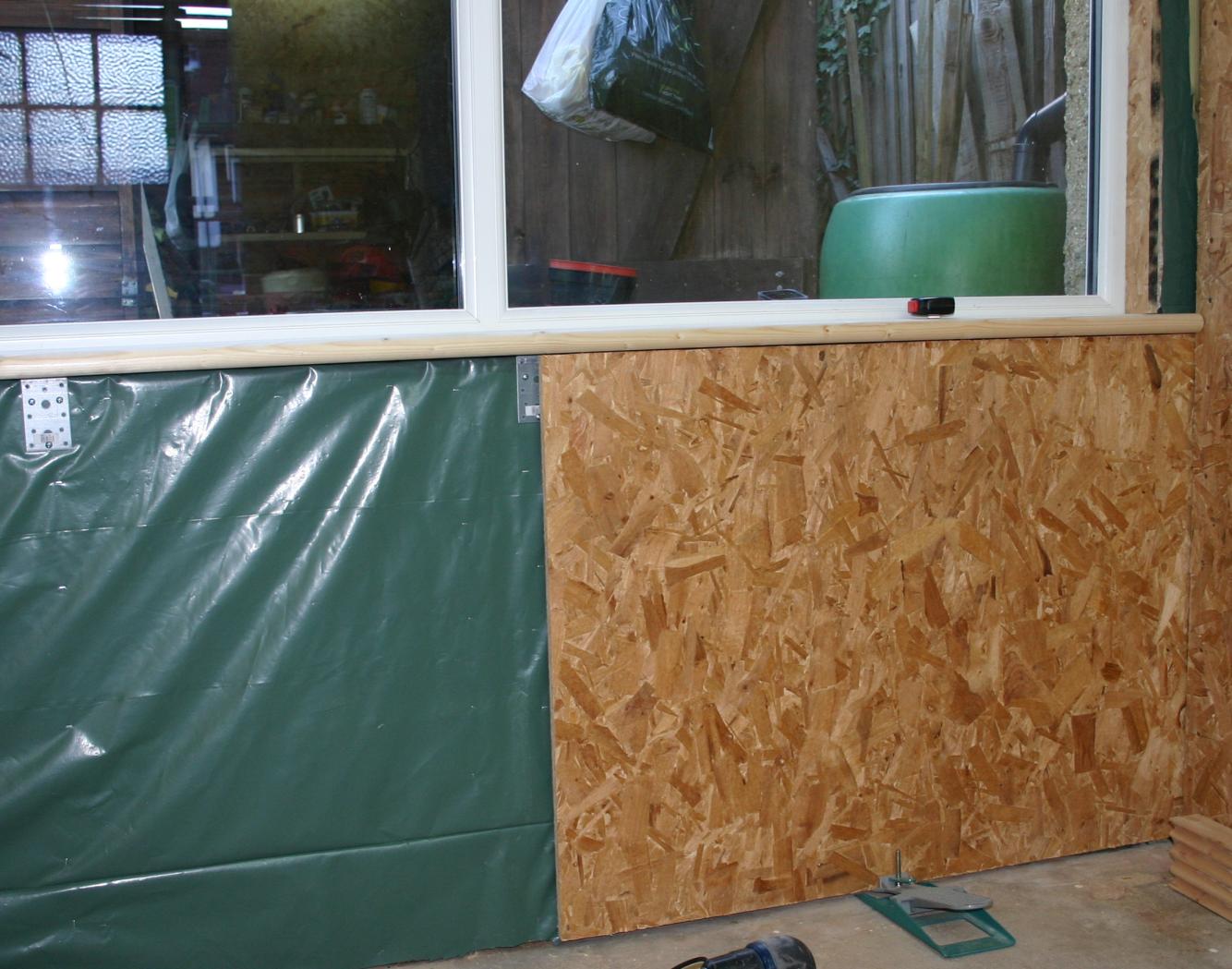 Work in progress sheathing beneath the window with OSB.