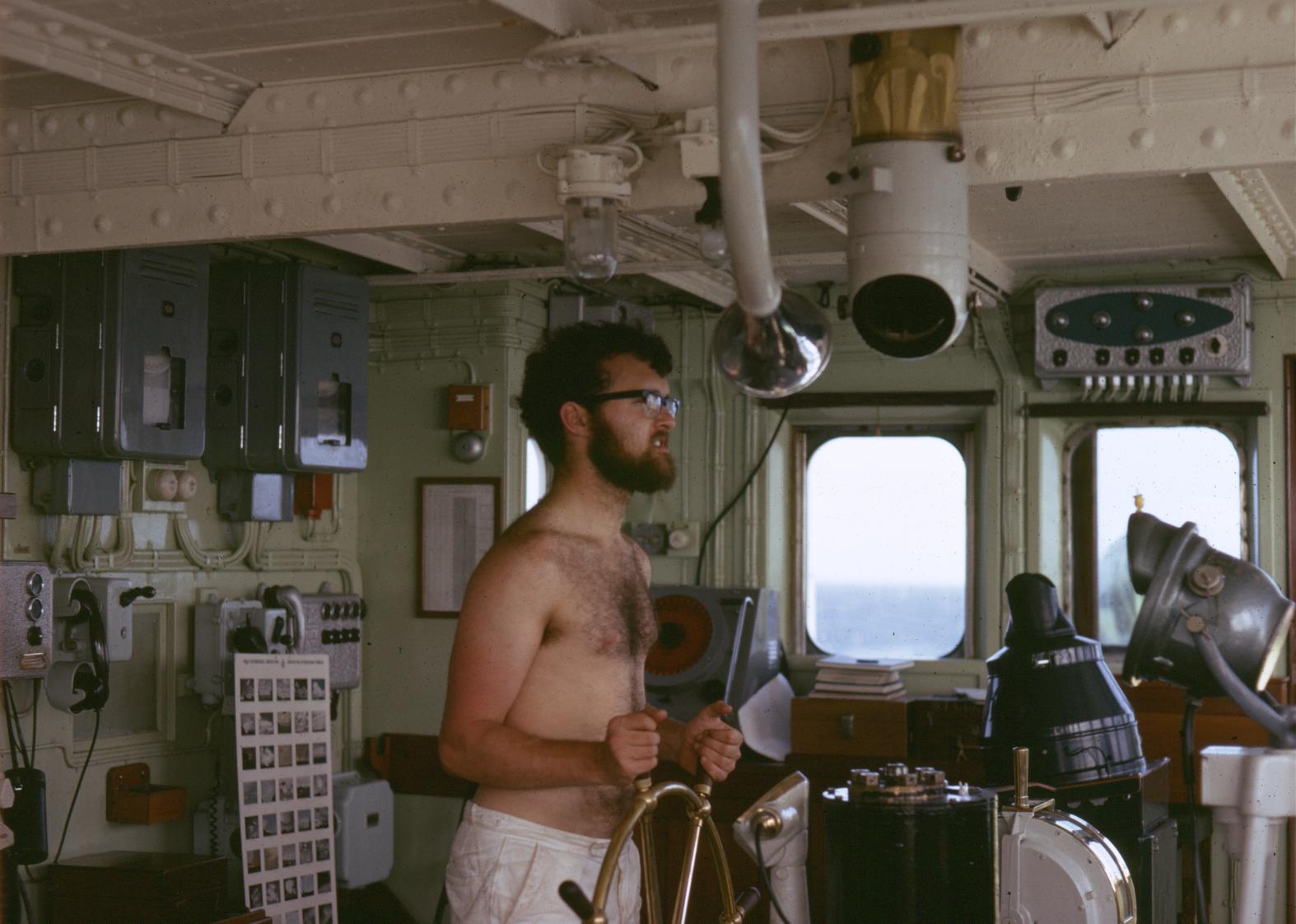 On wheel watch on the bridge of the John Biscoe, October 1972.