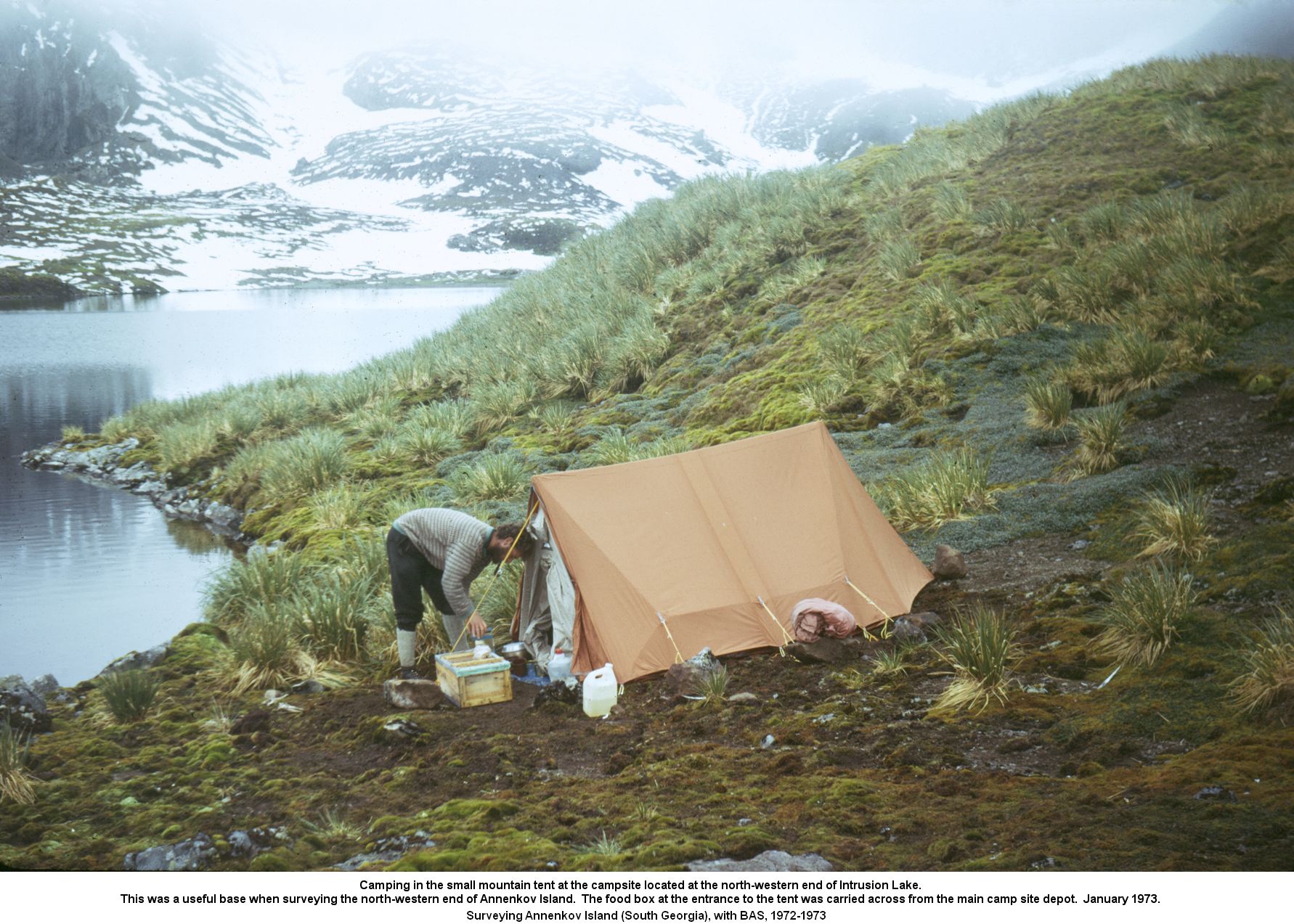 Camping in the small mountain tent at the campsite located at the north-western end of Intrusion Lake.
This was a useful base when surveying the north-western end of Annenkov Island.  The food box at the entrance to the tent was carried across from the main camp site depot.  January 1973.