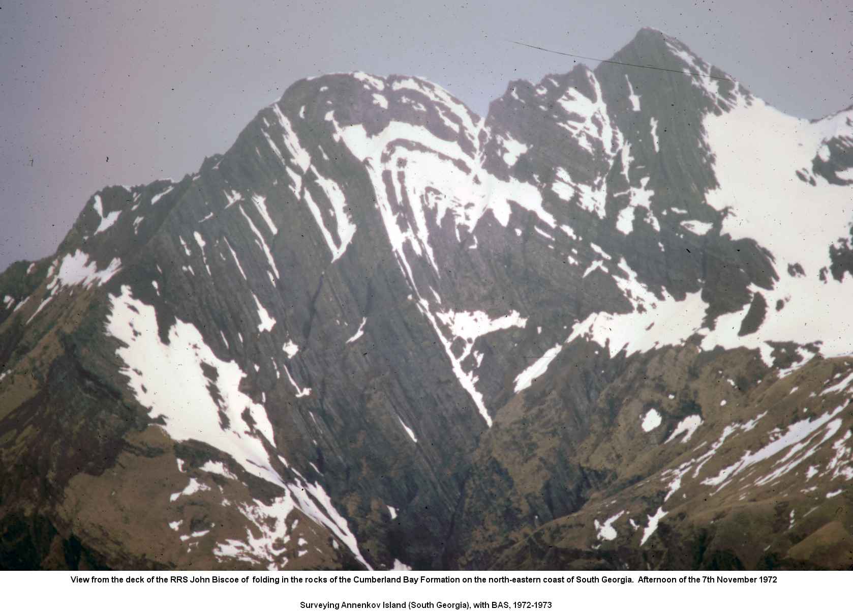 View from the deck of the RRS John Biscoe of  folding in the rocks of the Cumberland Bay Formation on the north-eastern coast of South Georgia.  Afternoon of the 7th November 1972.