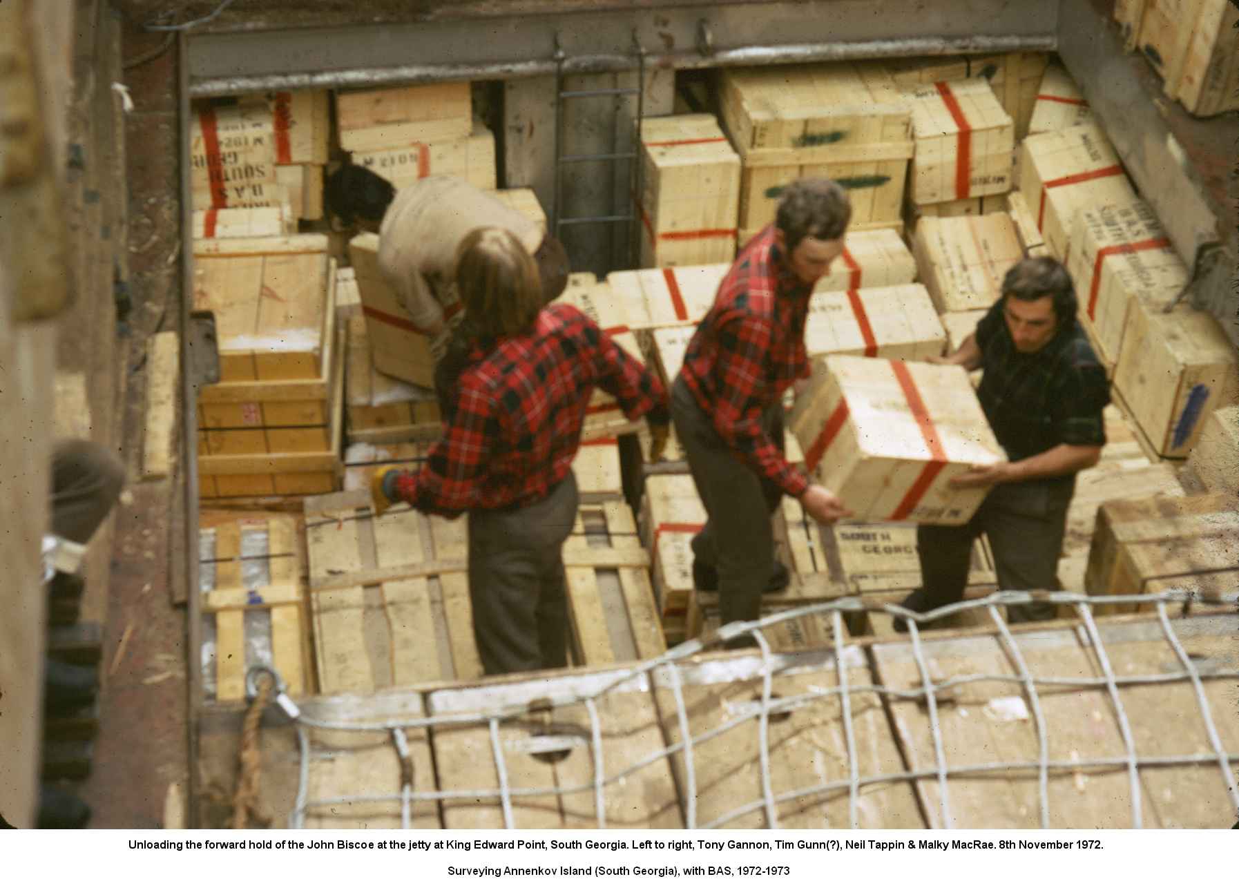 Unloading the forward hold of the John Biscoe at the jetty at King Edward Point, South Georgia. Left to right, Tony Gannon, Tim Gunn(?), Neil Tappin & Malky MacRae. 8th November 1972.