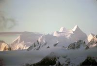 View from the deck of the RRS John Biscoe, looking north-east at the sun-lit peaks of South Georgia, at Queen Maud Bay on the evening of 13th November 1972.