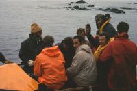 Gemini preparing to depart from the landing beach on the north-eastern coast of Annenkov Island, to the RRS John Biscoe after landing E. Lawther & T. Pettigrew. Personnel include, left to right; Pete Crockford (Bosun, waving), Eric Lawther, standing on extreme right of picture. 14th November 1972.