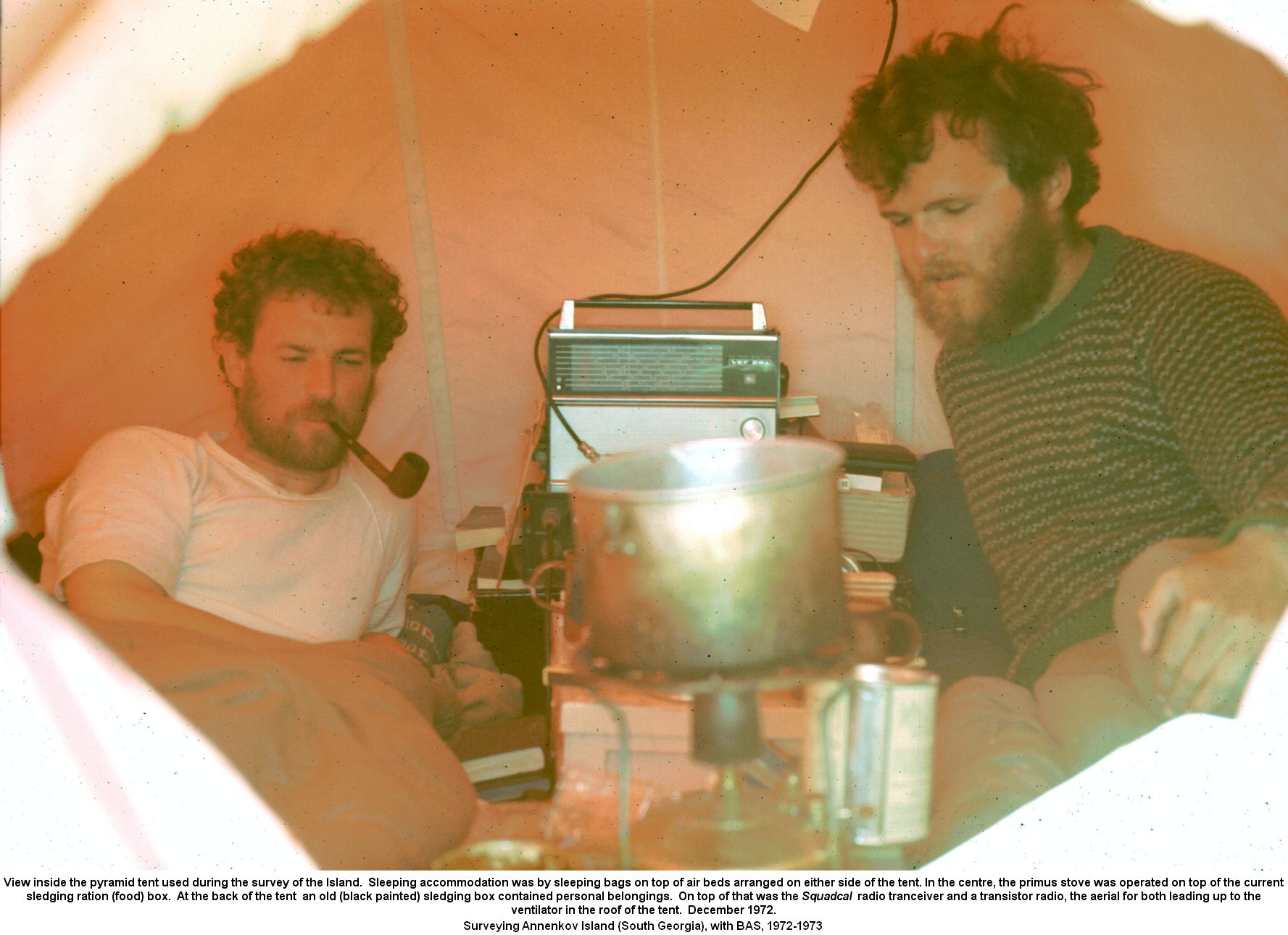 View inside the tent.  Sleeping accommodation was by sleeping bags on top of air beds arranged on either side of the tent. In the centre, the primus stove was operated on top of the current sledging ration (food) box.  An old (black painted) sledging box contained personal belongings.  On top of that was the Squadcal radio tranceiver the aerial leading up to the ventilator in the roof of the tent.  December 1972.