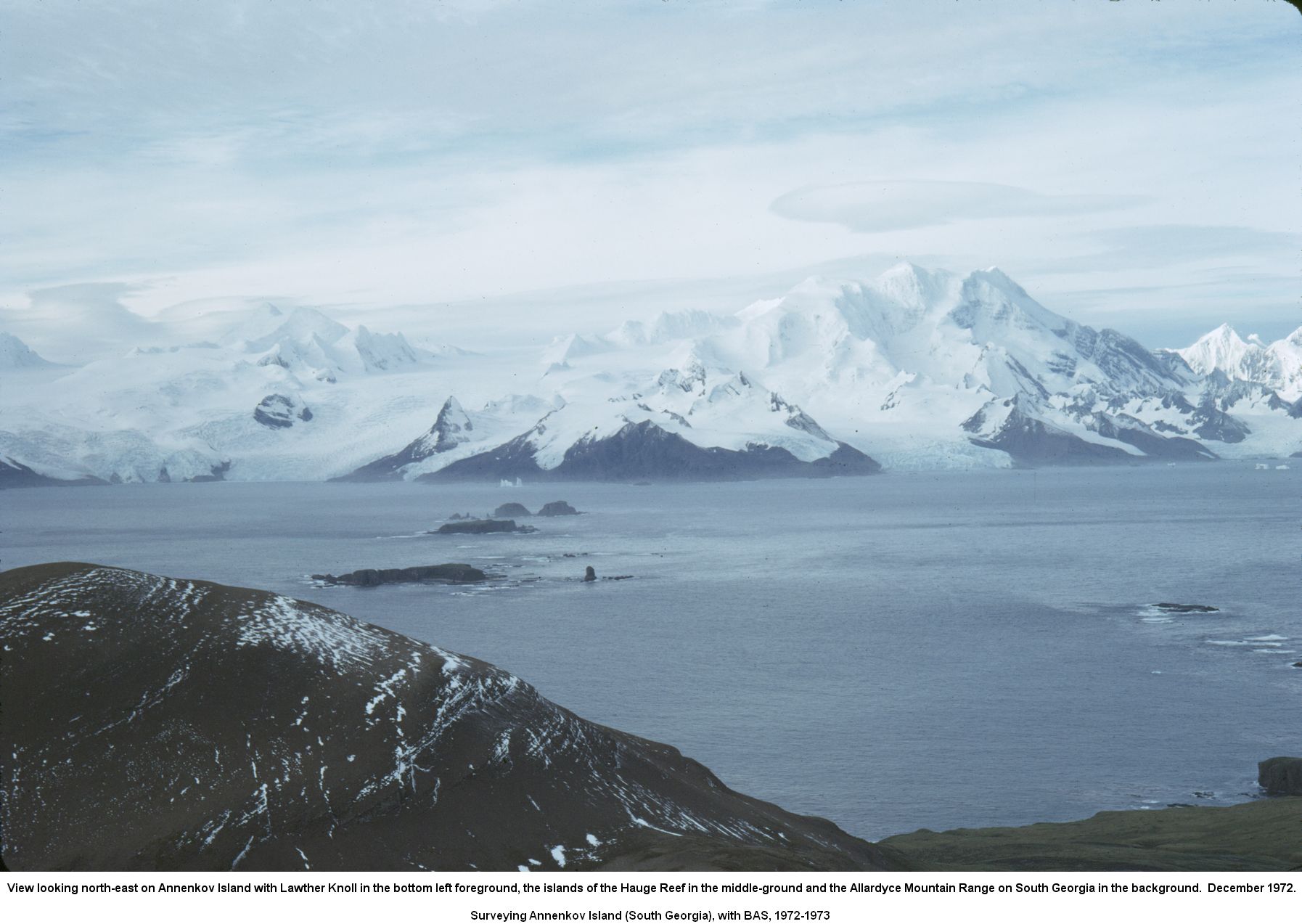 View looking north-east on Annenkov Island with Lawther Knoll in the bottom left foreground, the islands of the Hauge Reef in the middle-ground and the Allardyce Mountain Range on South Georgia in the background.  December 1972.