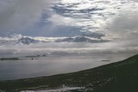 View looking east from the low col between Lawther Knoll and McPherson Crags on Annenkov Island, looking eastwards towards South Georgia. December 1972.